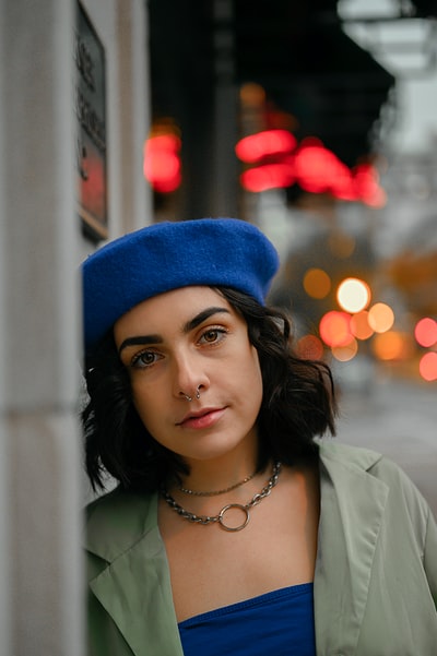 Woman wearing a white shirt blue knitted cap
